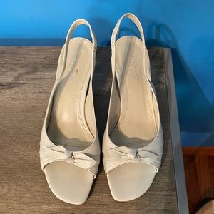 Off white kitten heels with bow detail.